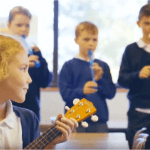 Children playing musical instruments in Musicl School class