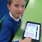 A boy uses a tablet to create a labelling activity on Purple Mash