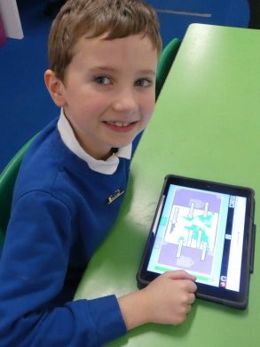 A boy uses a tablet to create a labelling activity on Purple Mash