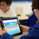 Pupils using Sumdog on tablets in class