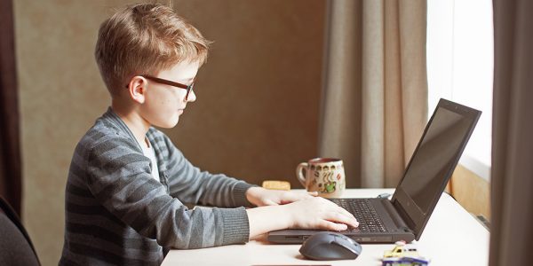 Boy at desk with laptop