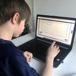 A child using an interactive arithmetic activity on Classroom Secrets Kids