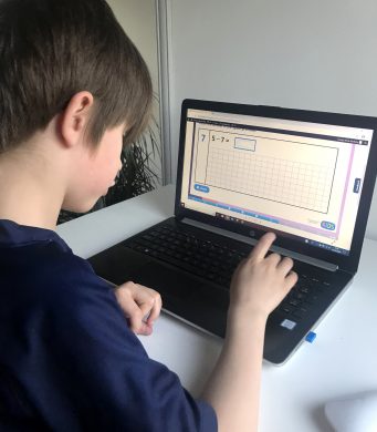 A child using an interactive arithmetic activity on Classroom Secrets Kids