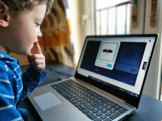 A young child using an interactive spelling game on Classroom Secrets Kids