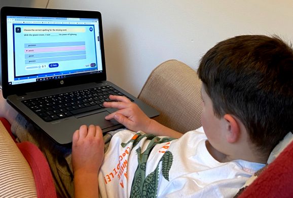 A child using an interactive grammar activity on Classroom Secrets Kids