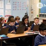 Primary school class using MyMaths on laptops