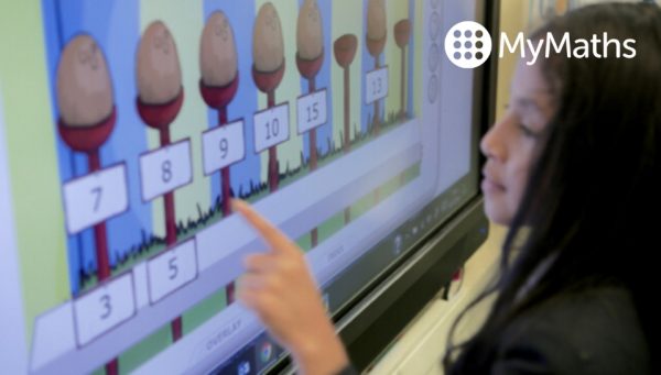 Primary school child using MyMaths on an interactive blackboard