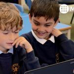 Primary school children using MyMaths on laptops